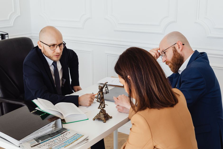 Attorney consulting with clients across a desk